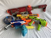 Photo showing all included toy guns and foam dart accessories in zippered bag