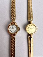 Both watches front view on light background