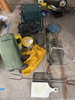 Photo showing all items including wader boots, rain jacket, fishing nets, pole, bait baskets, folding seat, wire lock, hiking stick, and lure box.
