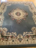 Full view of nylon floral area rug showing design and condition