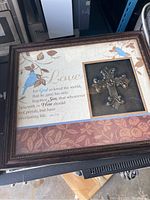 Full view of the framed biblical wall decoration showing cross and quote