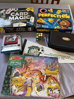 Overview of 7 items including games, puzzle, magic kit, and digital photo frame