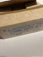 Original cardboard box labeled 'Lafayette 4 Channel Adapter QD-4' showing wear and identification details.