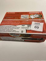 Front view of the product box showing model number TB110mw9a, brand Magnavox, and basic features including digital and analog TV conversion support.