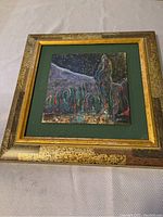 Photo of framed abstract painting showing whole artwork and frame with textured paint and dark starry night background.