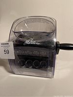 Front and side view of the coin sorter showing clear plastic body and handle