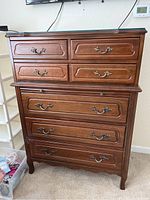 Front view of Chateau Provincial wood dresser with five drawers, brass handles, carved details, and custom glass top.