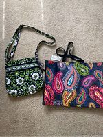 Two Vera Bradley bags: a green and white floral print quilted crossbody bag and a colorful paisley print tote
