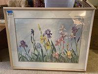 Full view of framed iris watercolor painting showing colorful iris flowers with mat and light wood frame.
