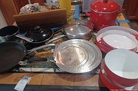 Overall view of all cookware items laid out on table