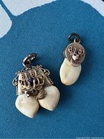 Photo showing smaller pendant with BPOE elk head and one attached elk tooth fob.
