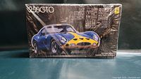 Front view of Fujimi Ferrari 250GTO 1/24 scale model kit box with factory shrink wrap intact, showcasing the detailed illustration of the blue and yellow Ferrari 250GTO.