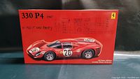 Front of box showing Ferrari 330P4 1967 red car model with race number 26 and schematic diagrams of parts.