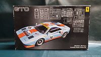 Top of the Fujimi Ferrari GTO 1/24 scale model kit box showing the car image and parts layout.