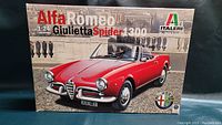 Front of the Italeri Alfa Romeo Giulietta Spider 1300 model kit box showing image of red convertible and product branding.
