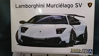 Box cover art showing white Lamborghini Murciélago SV model illustration with branding and model scale.