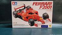 Front view of Tamiya Ferrari F2001 model kit box showing detailed car image and branding.