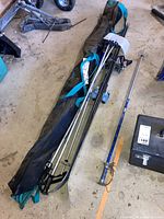 Photo showing two pairs of metal skis with bindings, four ski poles with different handle colors, and two black carrying bags on the floor.
