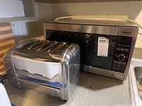 Photo showing both the Dualit 4-slice toaster and Panasonic microwave oven on a countertop.