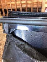 Close-up of folding cover rail and weatherstrip clamp