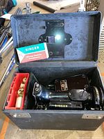 Machine and accessories inside open carrying case viewed from above