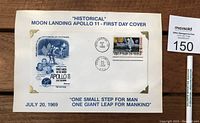 Full view of the mounted Apollo 11 First Day Cover with postmarks and stamps on white backing.