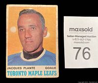 Front of Jacques Plante hockey card showing player image, team name, position and player name with wear and age discoloration visible.