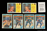 Front of select hockey cards showing portraits and action shots of players Wayne Gretzky, Mark Messier, Jari Kurri, and Paul Coffey.