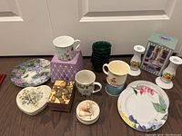 Overview of the lot showing various Easter and spring-themed dishware and decor items on the floor.