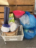 Photo of white milk crate containing ProWax 10 wax heater, Connoisseurs jewelry cleaner, wooden apple bushel basket, polishing pads, and plastic bowls along with two rolls of double draft door seals and large blue plastic bags with air packs.