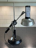 Full view of the vintage Prestige desk lamp showing the adjustable cantilever swing arm and metal shade positioned with cord wrapped around the base.