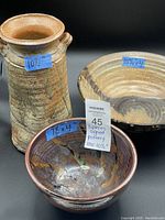 All three pottery pieces together showing size relationship and finishes