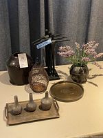 Group photo showing all decor pieces on a table against a gray curtain.