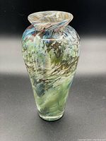 Full view of asymmetrical multi-coloured glass vase showing overall shape and color pattern.