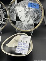 Overview showing two Hollohaza plates on stands, Alka Bavaria covered dish with lid and AK Kaiser bowl alongside lot label