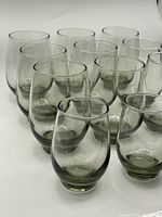 Set of 12 retro Libbey Tempo glasses with a smokey green hue, arranged in rows showing two sizes.