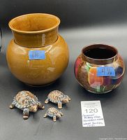 Overview of all items: caramel pottery vase, floral ceramic vase, and three Wade turtles in front