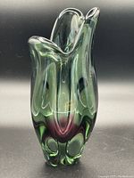 Front profile of green and red-purple Sommerso style glass vase showing base color blending and thick glass.