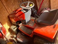 Left-front side view showing deck, foot pedal, and front wheel