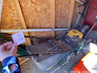 Overall shot of the Yard-Man lawn mower with grass catcher, showing general condition and size.