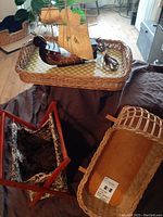 Photo of a wicker tray holding a wooden Santa Maria lamp and a wooden duck, next to a fabric-lined folding craft bag