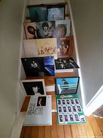 Full lot of 15 vinyl records arranged on stairs, showing album covers featuring classic rock and 70s-80s artists.