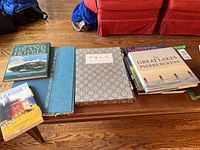 Overview of the coffee table books showing various titles including National Geographic atlas, China Scenes, Great Lakes