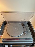 Full view of Dual CS 2110 turntable with clear lid open showing platter and tonearm