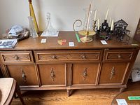Full front view of buffet with decorative items on top