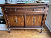 Front view of the cabinet showing drawer, doors, hardware and finish.