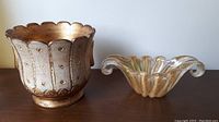 Italian planter and art glass bowl displayed side by side on table.