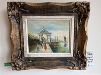 Full view of framed oil painting depicting pier scene with arch and boats.