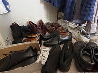 Wide view of 11 men's shoes in sizes 7-8 showing various styles including dress shoes, boots, and sneakers in worn condition.