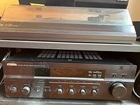 Front view of Yamaha RX-397 stereo receiver showing control knobs, display screen, and input options.